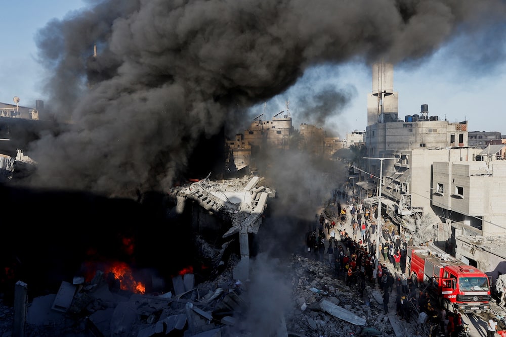Fire burns and smoke billows at a destroyed house after an Israeli strike.