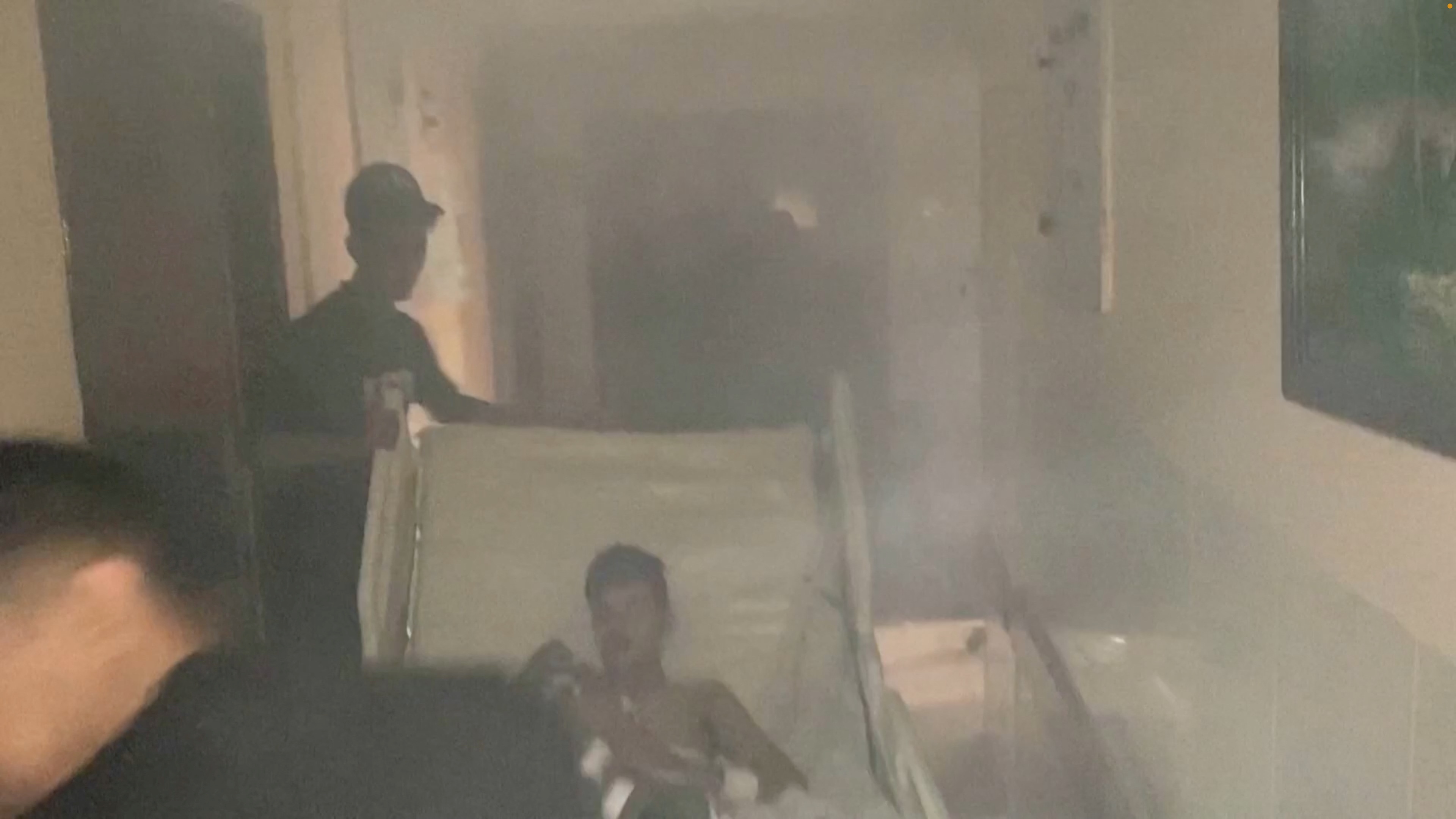 Medics move a patient through the smoke-filled corridors inside Al Shifa hospital following an Israeli raid, Nov. 15, 2023.