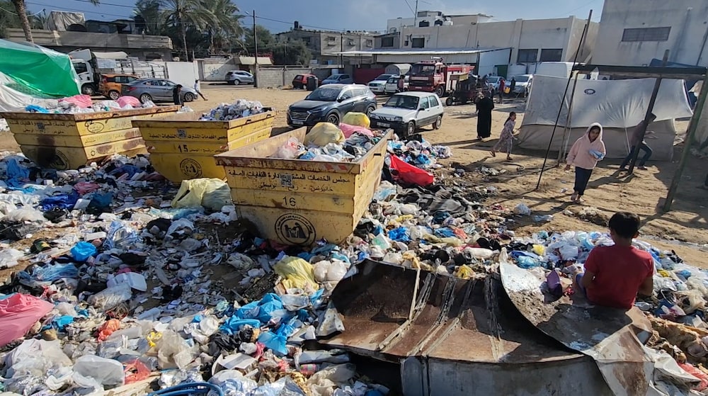 The accumulation of garbage near refugee tents, as depicted in this image taken in Deir El Balah, increases the risk of diseases.