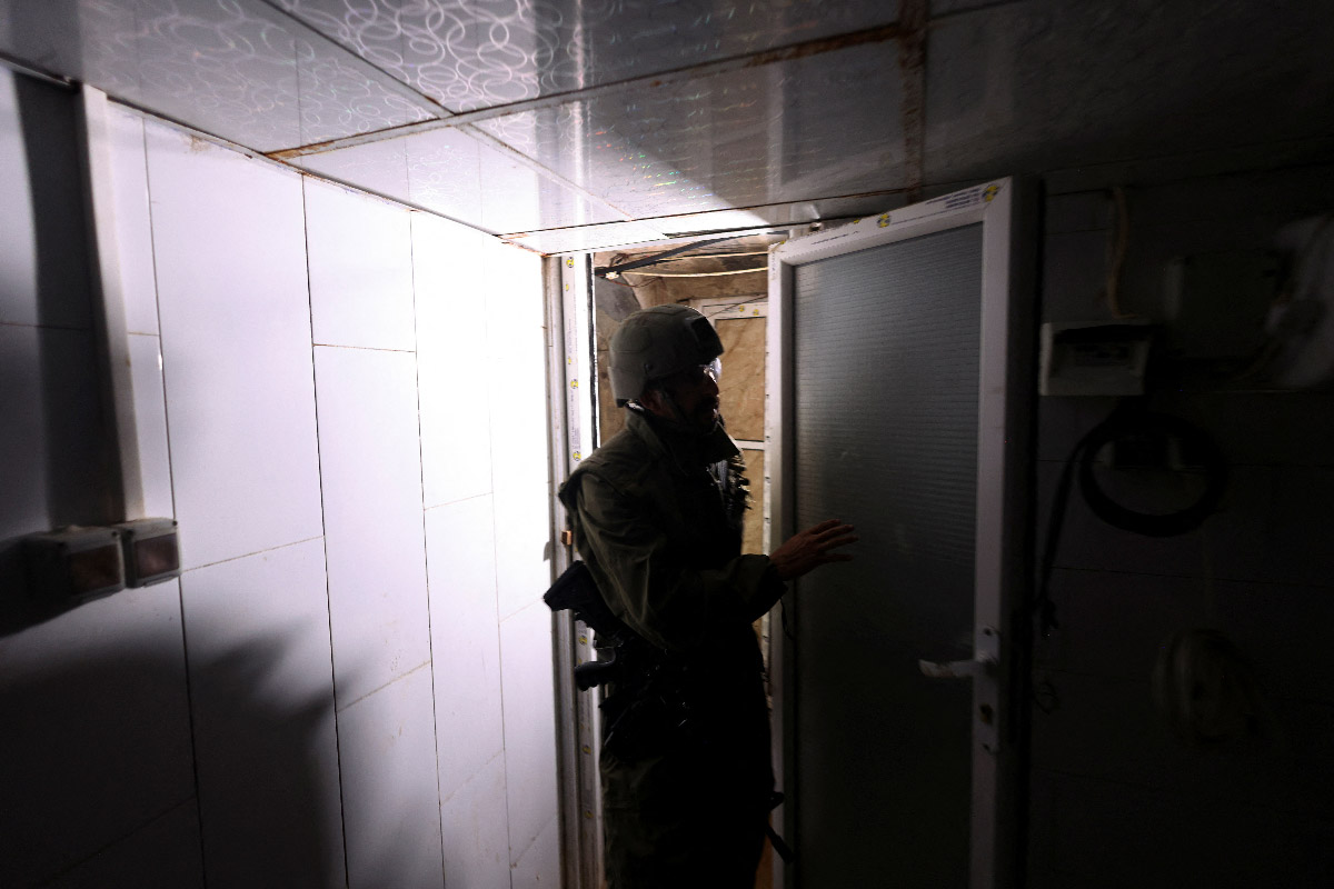 An image of an Israeli soldier standing in a room inside a tunnel underneath Al Shifa Hospital.
