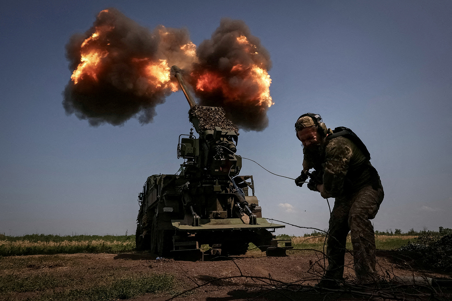 A Ukrainian serviceman of the 57th Kost Hordiienko Separate Motorised Infantry Brigade fires a 2S22 Bohdana self-propelled howitzer towards Russian troops at a position near the city of Bakhmut in Donetsk region, Ukraine, July 5, 2023. REUTERS/Sofiia Gatilova