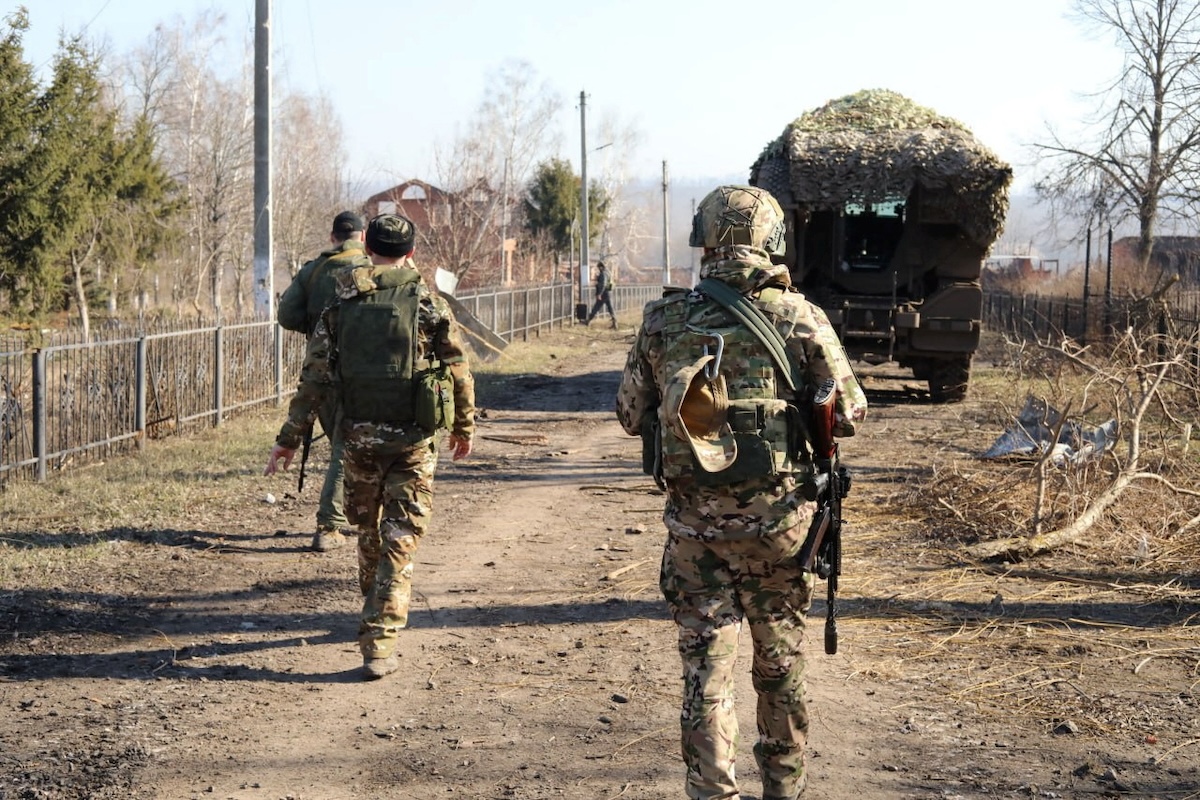 Russian service members walk along a street in a part of the Kursk region, which was retaken by Russia's armed forces in this image released March 14, 2025.